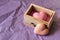 Spa and wellness concept: wooden box with pink sea salt and heart shape soap with word `love` on it