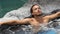 Spa wellness - man relaxing in hot tub whirlpool jacuzzi outdoor luxury resort