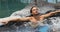 Spa wellness - man relaxing in hot tub whirlpool jacuzzi at resort