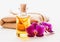 Spa and wellness setting with orchid flowers and oil on white background