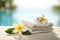 Spa, wellness setting, towels, frangipani flowers.