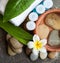 Spa or wellness stones in the bowl of water, towel and cream