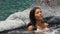 Spa wellness - woman relaxing in hot tub whirlpool jacuzzi at resort