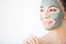 Spa Woman applying Facial cleansing Mask. Beauty Treatments