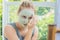 Spa Woman applying Facial green clay Mask. Beauty Treatments. Cl