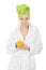 Spa woman in bathrobe holding orange.