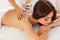 Spa Woman. Brunette Getting a Salt Scrub Beauty Treatment in the