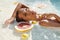 SPA Woman In Pool With Citrus. Beautiful Girl With Fresh Tropical Fruit Relaxing At Resort.