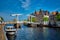 Spaarne river with boat and Gravestenenbrug bridge in Haarlem, N