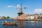 Spaarne river with canal boat and windmill, Haarlem, Netherlands