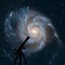 Space background with silhouette of telescope. Pinwheel Galaxy