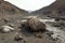 spacecraft remains in a dried-up riverbed with cracked earth