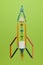Spaceship rocket from stationery on green background. Child imagination, science in elementary school. preschool