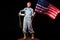 spacewoman in spacesuit holding helmet and american flag