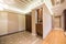 Spacious anteroom interior in warm tones and modern ceiling lights