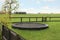 Spacious backyard with trampoline and wooden fence in early morning