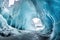 a spacious cavern within a glacier with artful icicle formations