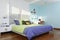 Spacious, clean and colorful child`s bedroom with sunlight coming through the windows