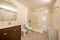 Spacious cloakroom with square frameless mirror, glass-enclosed shower stall and white toilets