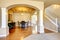 Spacious dining room with white columns and beige tray ceiling.