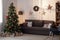 Spacious domestic room with couch, lamp, armchair and xmas tree