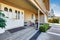 Spacious entrance porch with white Double front doors of luxury home.