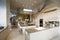 Spacious Kitchen With Stools At Island In House