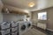 Spacious laundry room with window and lots of storage baskets