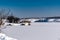 Spacious snow landscape. River and hills in Russia, white winter on the terrain, a lot of fluffy snow and ice under a beautiful bl