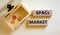 SPACs market symbol. Wooden blocks with words `SPACs, special purpose acquisition companies market` on beautiful white backgroun