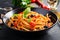 Spaghetti alla puttanesca - italian pasta dish with tomatoes, black olives, capers,