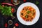 Spaghetti alla puttanesca - italian pasta dish with tomatoes, black olives, capers, anchovies