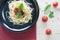 spaghetti on back dish with fresh tomatoes basil italian herbs