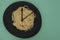 Spaghetti on a black plate, on green background, clock tongues representing boiling time