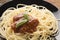 Spaghetti bolognese in black plate on wooden table background,Spaghetti with Spicy Mixed sauce and meat