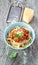 Spaghetti bolognese in blue bowl on vintage rustic wood