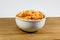 Spaghetti Bolognese in a deep white bowl on the wooden kitchen table waiting to be eaten