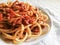 Spaghetti Bolognese with minced beef, onion, chopped tomato, garlic, olive oil, stock cube, tomato puree and Italian herb.