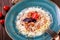 Spaghetti bolognese with minced beef, tomato sauce garnished with parmesan cheese and basil on the plate.