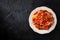 Spaghetti bolognese pasta, shot from above on a dark table