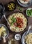 Spaghetti with canned mussels and tomato sauce. On a wooden table, top view. Flat lay.