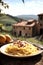 Spaghetti Carbonara with bacon and parmesan cheese on wooden table in Tuscany, Italy.