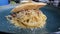 Spaghetti carbonara creamy beef bacon sauce, onion, garlic, sauted mushrooms, parmesan cheese and egg yolk serve in a blue plate