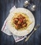 Spaghetti with delicious meatballs made from ground beef in a spicy tomato sauce with salt pepper and fork in a plate with