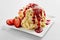 Spaghetti ice cream with strawberry topping