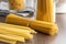 Spaghetti and mafaldine pasta. Uncooked italian pasta on wooden table