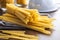 Spaghetti and mafaldine pasta. Uncooked italian pasta on wooden table