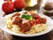 Spaghetti and meatballs with basil garnish