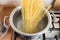 Spaghetti in pan cooking in boiling water