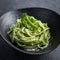 Spaghetti pasta with kale pesto sauce and parmesan cheese